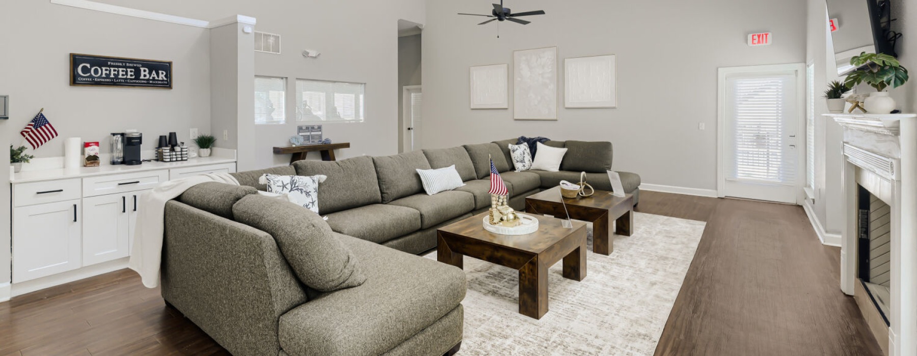 a spacious room with a large sofa and a fireplace