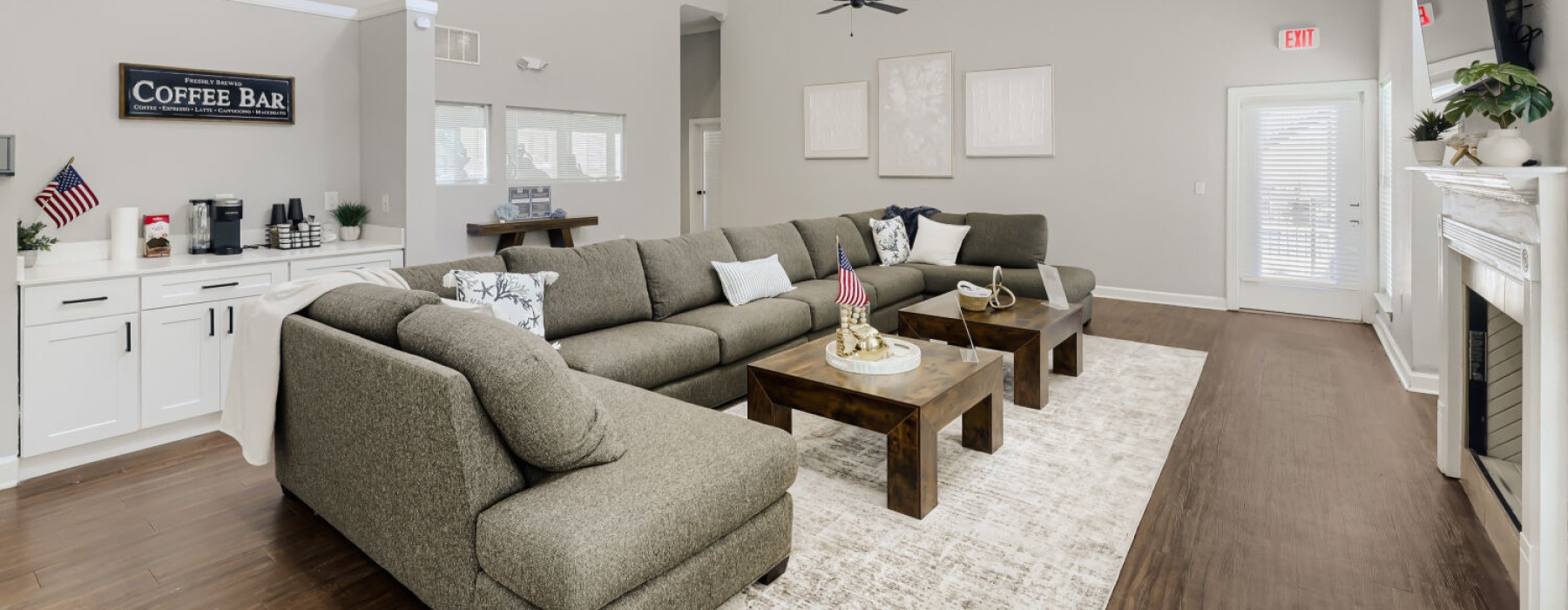 a spacious room with a large sofa and a fireplace