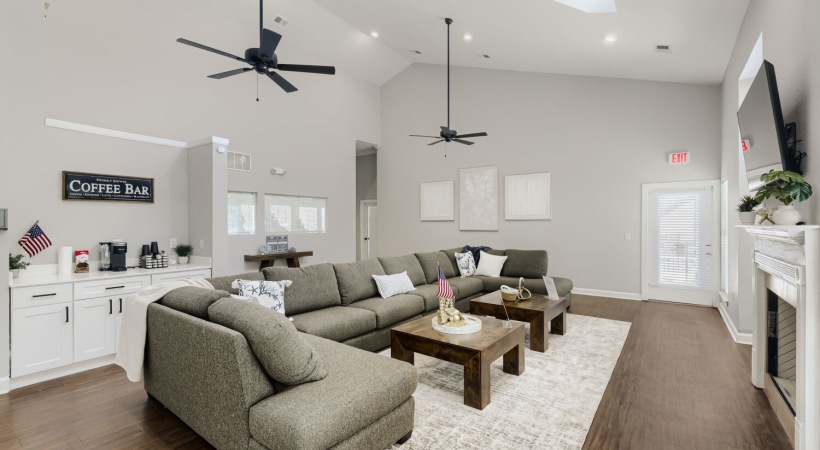 a spacious room with a large sofa and a fireplace