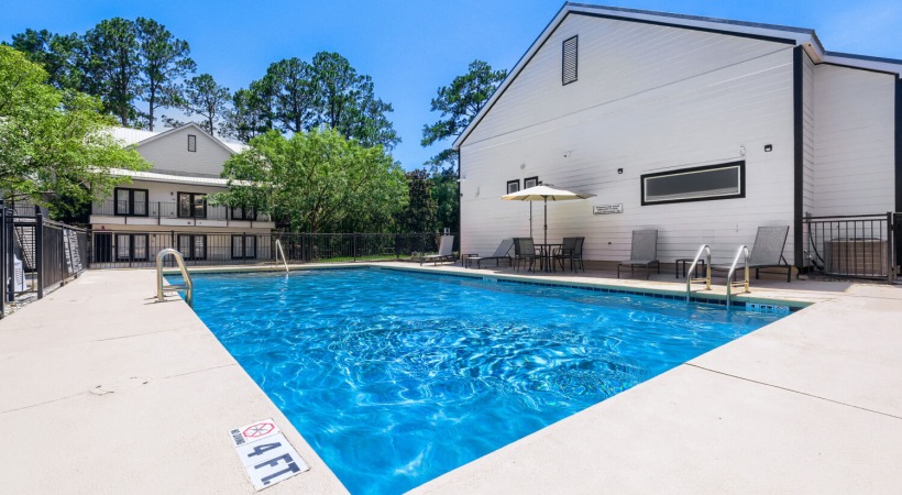Resort-style swimming pool with lounge seating
