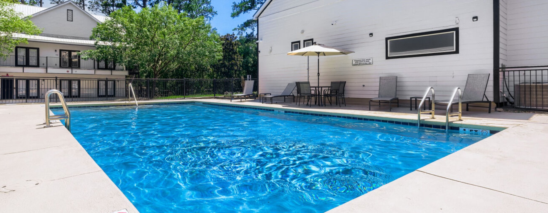 Resort-style swimming pool with lounge seating