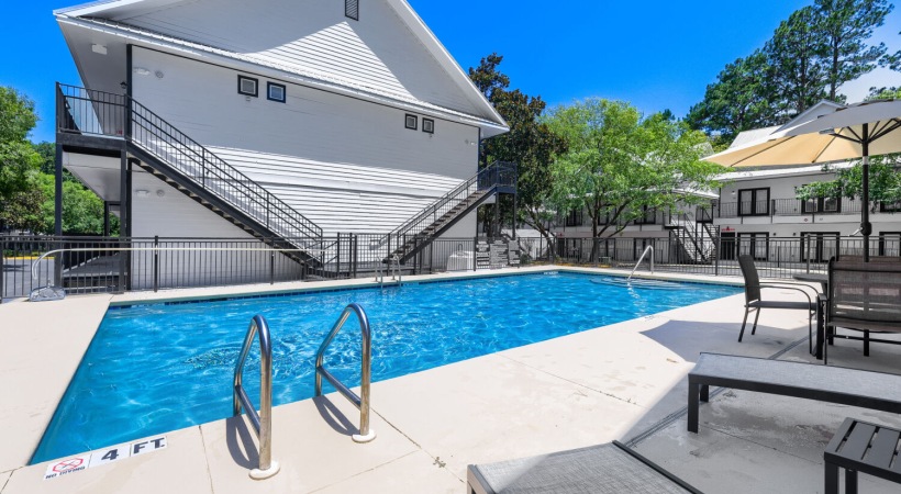 Resort-style swimming pool with lounge seating