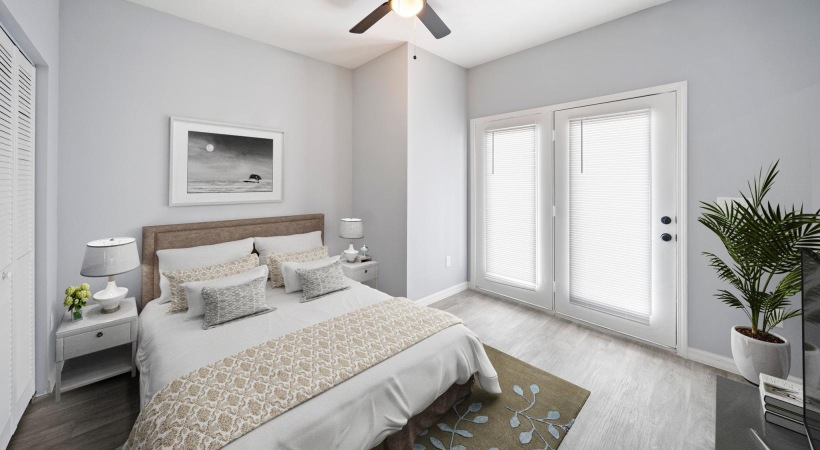 a bedroom with a ceiling fan and a bed