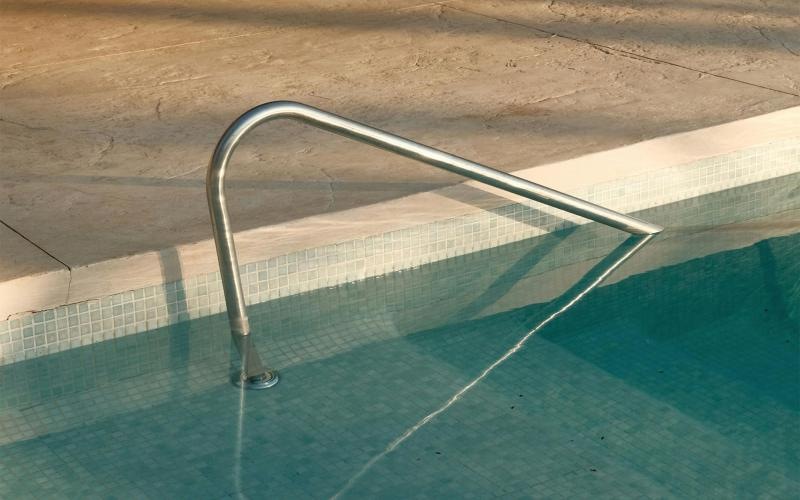 a pool with chairs around it